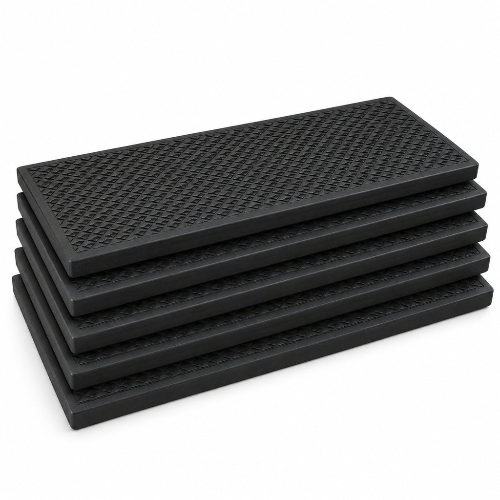 Five black textured rubber stair treads stacked