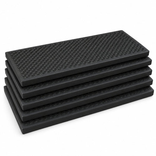 Five black textured rubber stair treads stacked