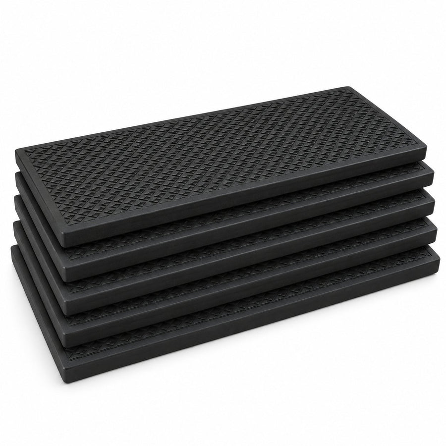 Stack of five black rubber stair treads